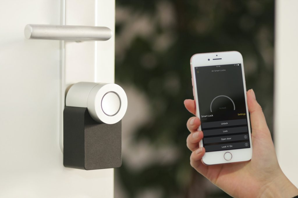Home Security Setups - Digital lock on a door being opened by a phone app