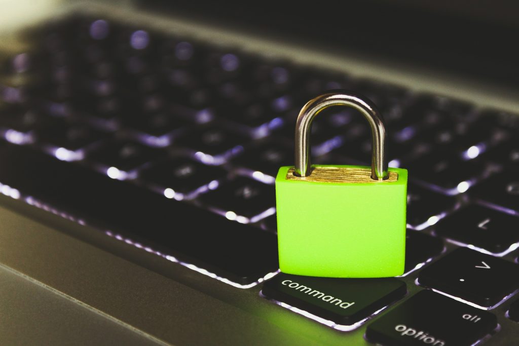 Cybersecurity Attack Trends - fluorescent coloured padlock sitting on a computer keyboard