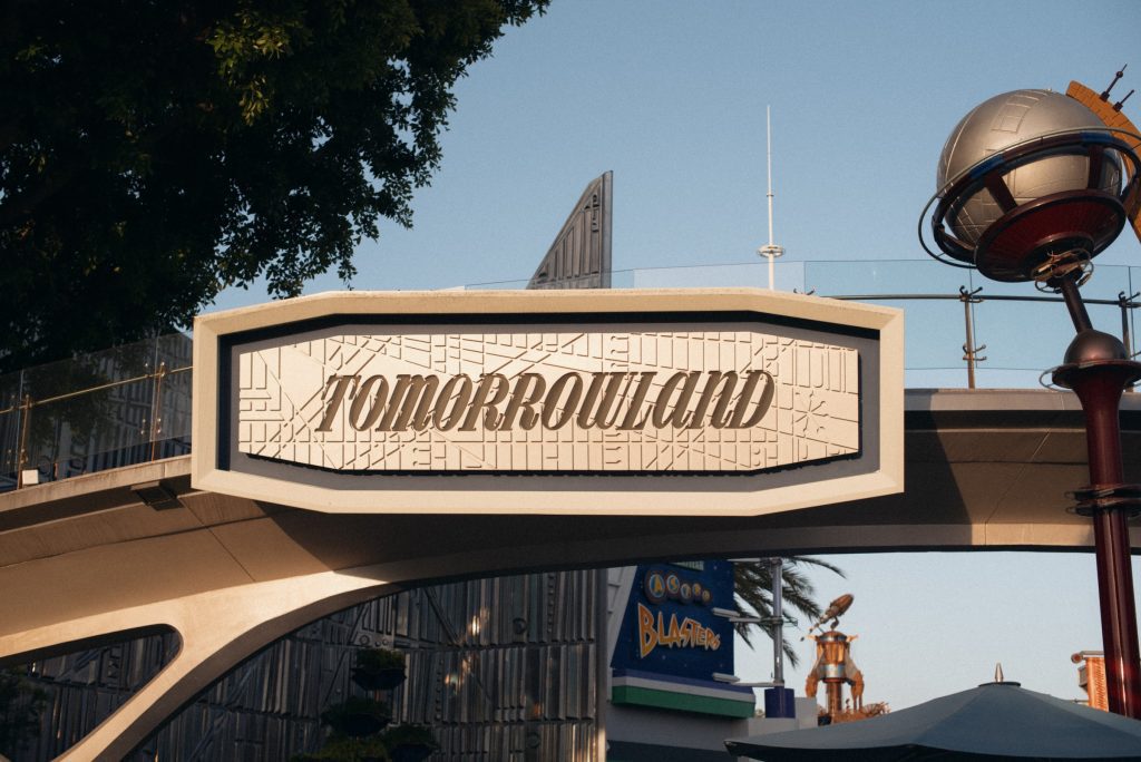 Metaverse: The word 'Tomorrowland' on a sign at at space age theme park.