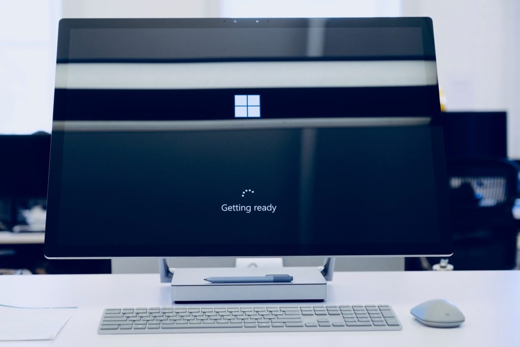 Windows 11 Features - large Mac computer on a desk with the boot up screen showing